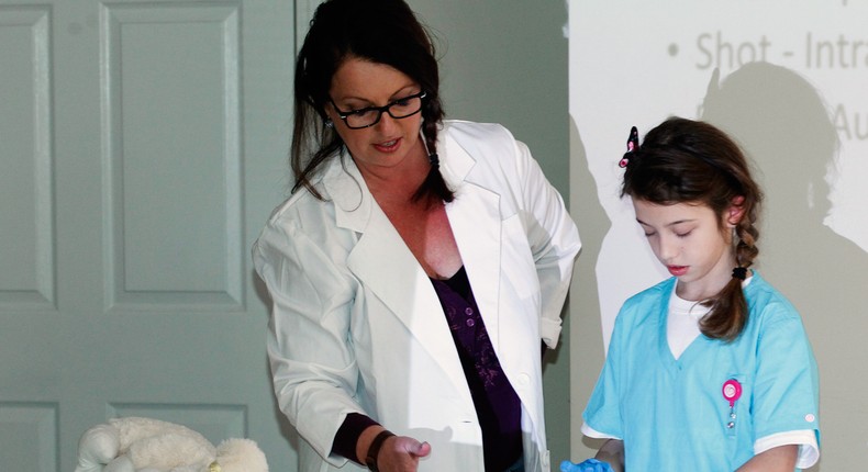 Jennifer Stepp (L) and her daughter Audrey, 8, teach a Naloxone training class for children and adults on how to save lives by injecting Naloxone into people suffering opioid overdoses at the Hillview Community Center in Louisville, Kentucky, November 21, 2015.