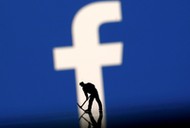 FILE PHOTO: A figurine is seen in front of the Facebook logo in this illustration