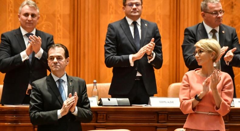 Romanian Prime Minister Ludovic Orban is applauded by members of his cabinet after a vote for a new government at the Romanian Parliament in Bucharest on November 4, 2019