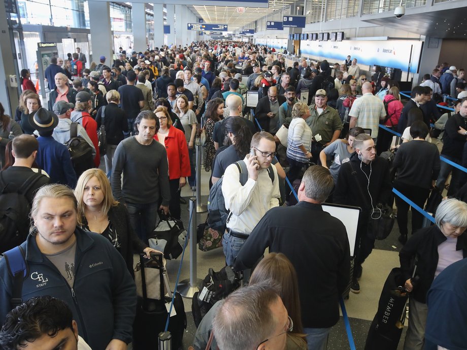 Passengers at O'Hare International Airport, in Chicago, wait in line to be screened at a TSA checkpoint.