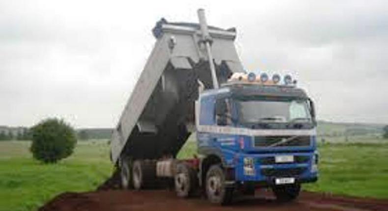 A sand truck dislodging its content