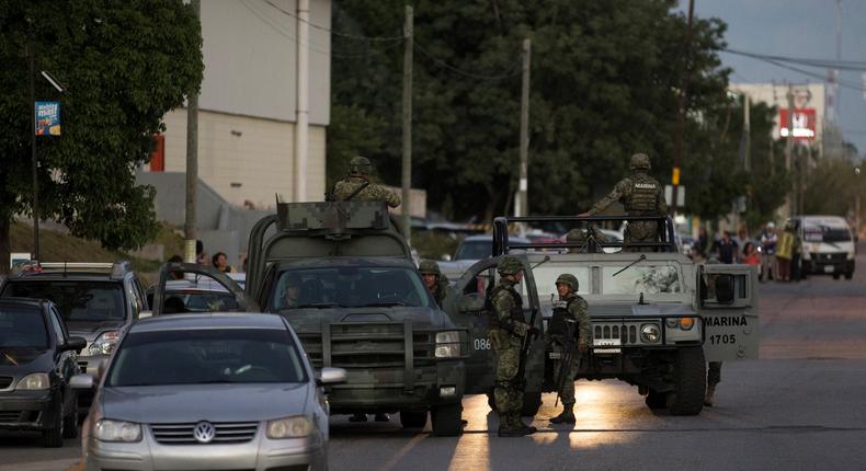 Soldiers guard the perimeter after an armed group shot at the attorney general's office, according to local media, in Cancun, Mexico, January 17, 2017.