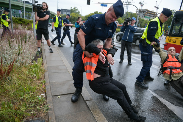 Warszawa. 07.07.2024. Aktywistka Katarzyna Augustynek (C) podczas protestu organizacji Ostatnie Pokolenie na jezdni przy galerii handlowej Westfield Mokotów w Warszawie, 7 bm. Ostatnie Pokolenie to grupa aktywistów ekologicznych działających na rzecz walki ze zmianami klimatycznymi. (sko) PAP/Marcin Obara