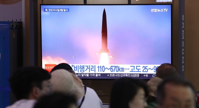 People watch a TV broadcast about a North Korean missile launch at the Seoul Railway Station, June 5, 2022.