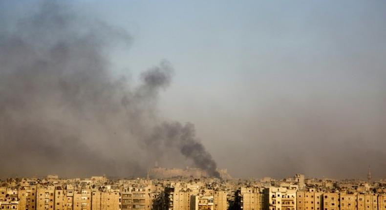 Smoke billows from the former rebel-held district of Bustan al-Qasr in Aleppo, on December 12, 2016