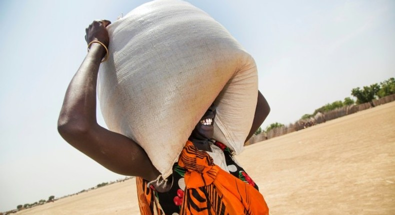 A woman carries a sack of food distributed in Ganyiel, Panyijiar county, in South Sudan