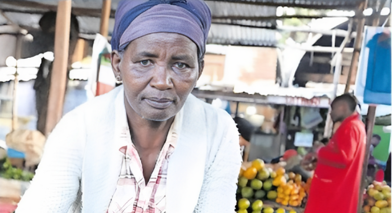 Pauline Waithira selling avocados in the market
