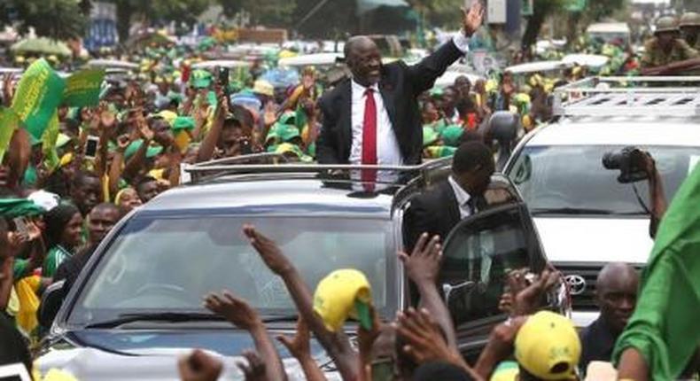 Tanzanias President elect John Pombe Magufuli (C) salutes members of the ruling Chama Cha Mapinduzi Party (CCM) as he arrives at the partys sub-head office on Lumumba road in Dar es Salaam, October 30, 2015.