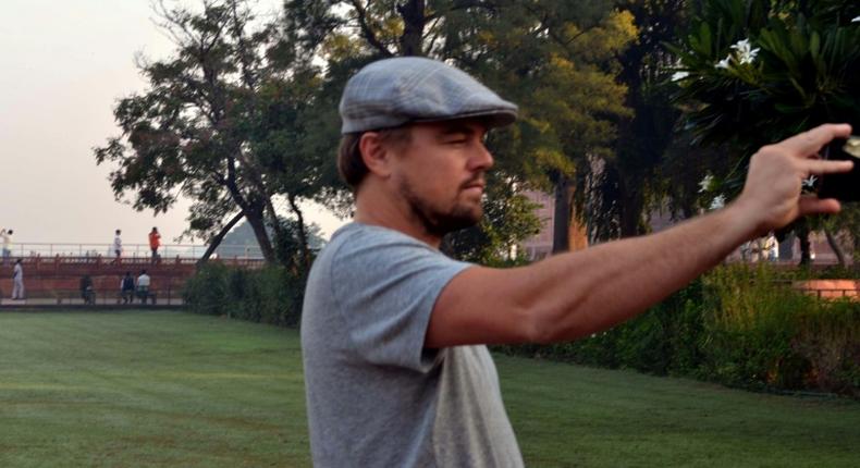 Hollywood star Leonardo DiCaprio takes a photograph in the gardens of the Taj Mahal during a visit to India in 2015