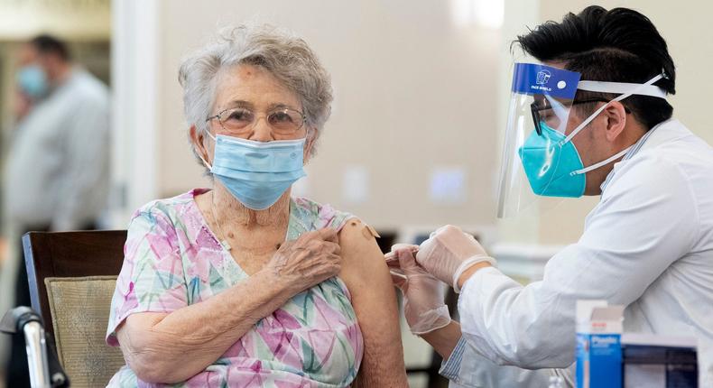 A CVS pharmacist gives the Pfizer/BioNTech COVID-19 vaccine to a resident at the Emerald Court senior living community in Anaheim, California.