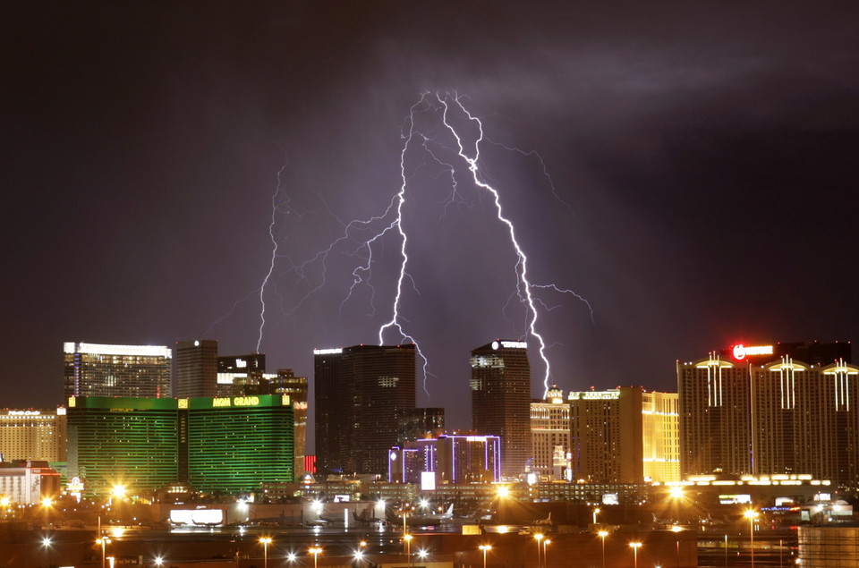 Lightning flashes over Strip casinos as a thunderstorm passes through the Las Vegas Valley in Las Vegas, Nevada October 19, 2010.