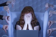 Girl with laptop covering face