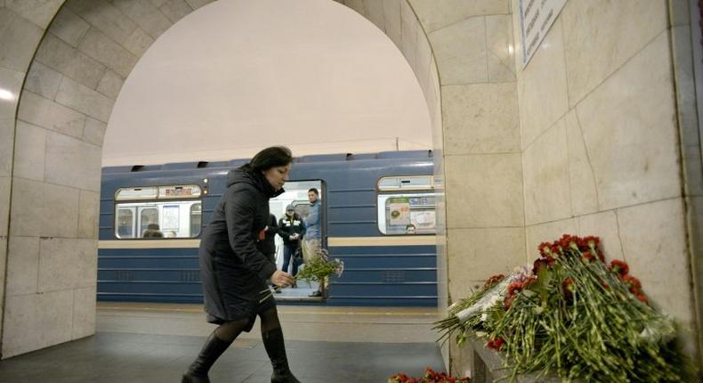 A woman places flowers in honour of the victims of the April 3 attack on the Saint Petersburg metro