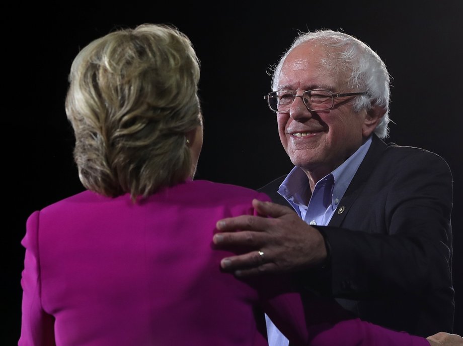 Democratic presidential nominee Hillary Clinton (L) and U.S. Sen Bernie Sanders (I-VT) embrace during a campaign rally at Coastal Credit Union Music Park at Walnut Creek on November 3, 2016 in Raleigh, North Carolina. The U.S. presidential general election is November 8.