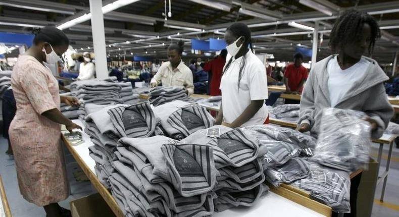 Kenyan workers pack clothes for export at the Alltex export processing zone (EPZ) factory in Athi River, near the Kenyan capital Nairobi, July 31, 2009. REUTERS/Thomas Mukoya