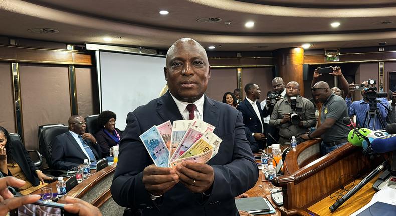John Mushayavanhu, Governor of the Reserve Bank of Zimbabwe, presents the new national currency Zimbabwe Gold, or ZiG.Columbus Mavhunga/picture alliance/Getty Images