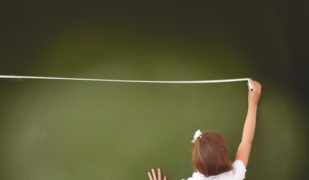 622688_stockphotoscoolgirlstandinginclassnearagreenblackboard118792492