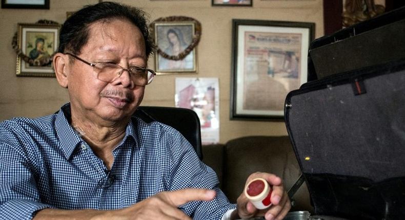 Frank Malabed, the embalmer of the late Philippine dictator Ferdinand Marcos, shows the make-up kit that he uses for his job