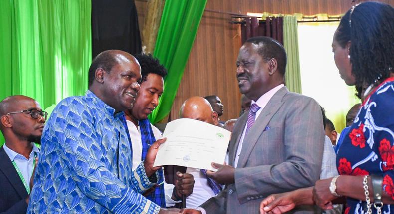 IEBC Chairperson Wafula Chebukati hands Azimio coalition's presidential candidate Raila Odinga official clearance to vie in the 2022 election on June 5, 2022 at the Bomas of Kenya National Tallying Centre