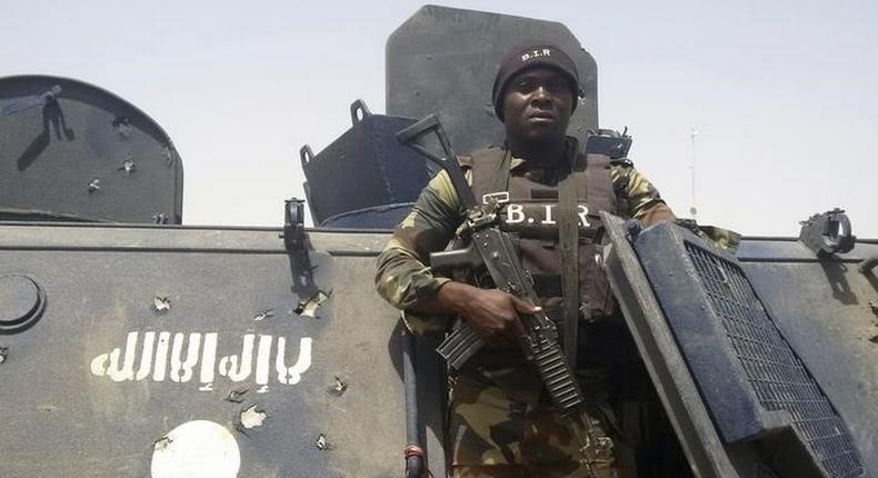 A Cameroonian soldier stands on a Nigerian armoured vehicle used by Boko Haram insurgents to attack a Cameroon army patrol near Waza, February 17, 2015. REUTERS/Bate Felix Tabi Tabe