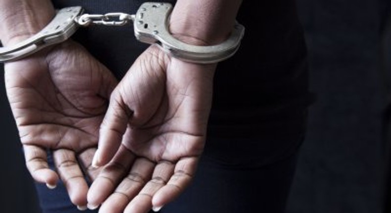 A woman handcuffed by police 