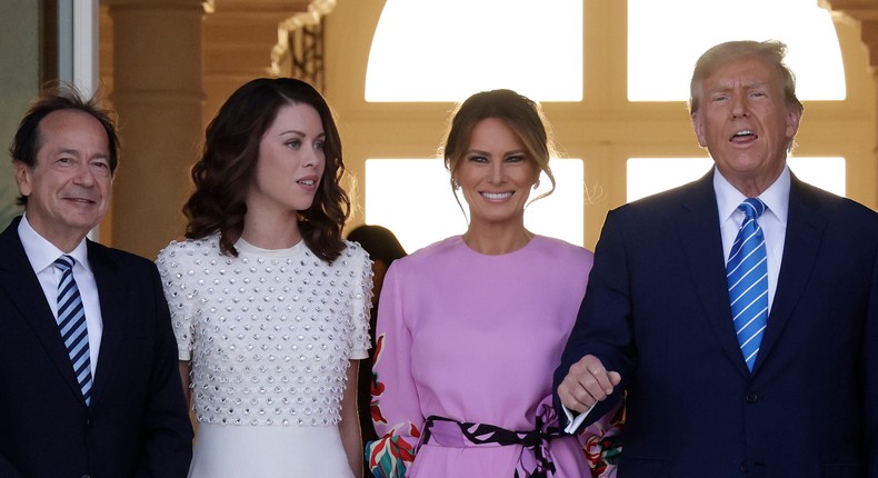 John Paulson and Alina de Almeida with Melania and Donald Trump in April.Alon Skuy/Getty Images