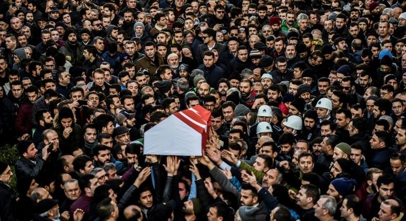 People carry the coffin of Yunus Gormek, 23, one of the victims of the Reina night club attack, during his funeral ceremony on January 2, 2017 in Istanbul