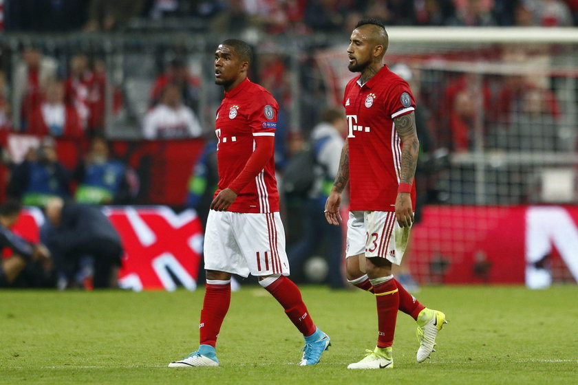 Bayern Munich's Arturo Vidal looks dejected after being sent off as Real Madrid's Sergio Ramos looks