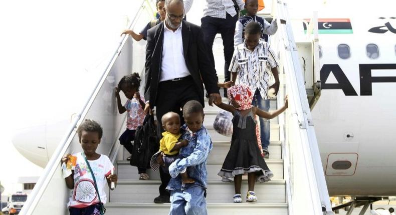 Sudanese children whose parents were reportedly jihadists in Libya get off a plane in Khartoum on June 20, 2017