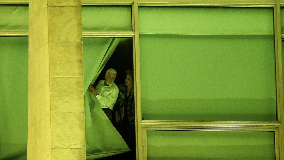 Brazil's President Rousseff and Chief of Staff Wagner look from a window at Planalto Palace in Brasi