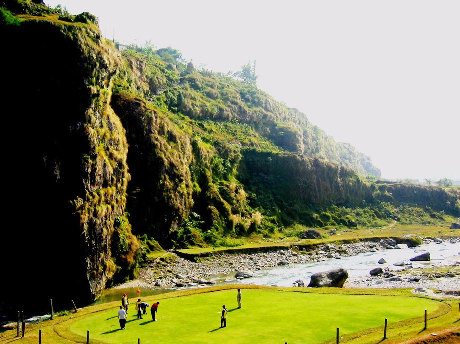 For a game unlike any other, head to the Himalayan Golf Course in Pokhara, Nepal. Once you arrive, you'll find a stunning natural amphitheater with mountain views and a river that runs right through the course.