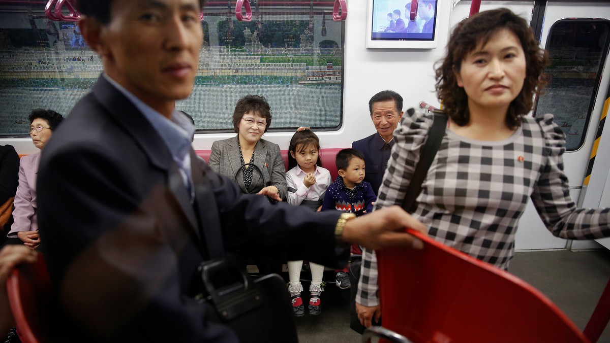 Passengers travel on a recently introduced new train during a government organised visit to the subway for foreign reporters in central Pyongyang