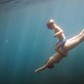 Underwater view of boy and mother diving