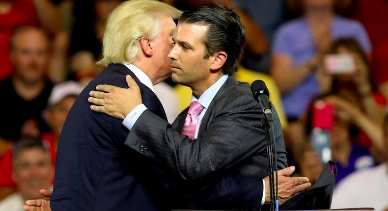 Republican U.S. presidential candidate Donald Trump hugs his son Donald Trump Jr. at a campaign rally in St. Clairsville, Ohio