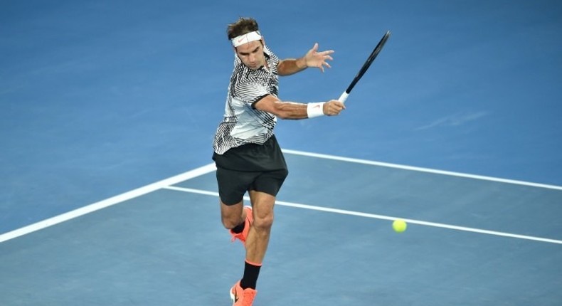 Roger Federer of Switzerland hits a return against Rafael Nadal of Spain during the men's singles final during the Australian Open tennis tournament January 29, 2017