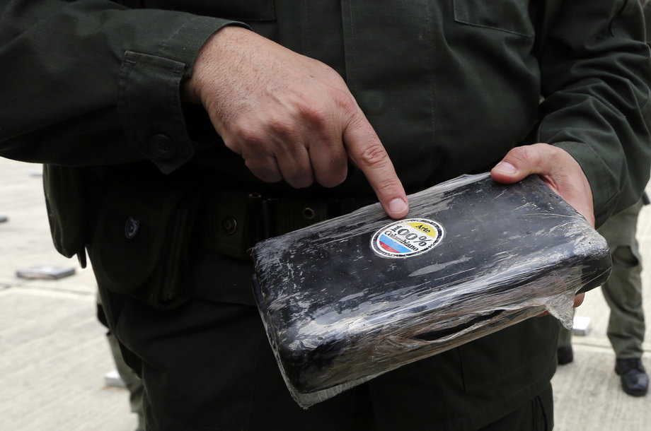 A Colombian official with a confiscated pack of cocaine at the police base in Necocli, northern Colombia, March 11, 2015.