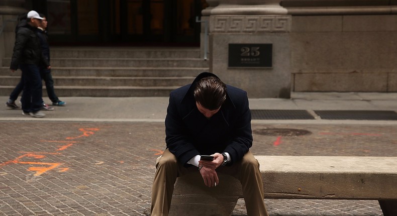 A man pauses outside of the New York Stock Exchange (NYSE) on January 15, 2016 in New York City.