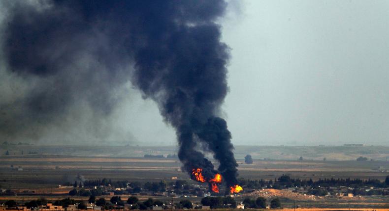 In this photo taken from the Turkish side of the border between Turkey and Syria, in Ceylanpinar, Sanliurfa province, southeastern Turkey, flames and smoke billow from a fire on a target in Ras al-Ayn, Syria, caused by shelling by Turkish forces, Thursday, Oct. 17, 2019. U.S. Vice President Mike Pence and State Secretary Mike Pompeo were scheduled to arrive in Ankara Thursday and press Turkey's President Recep Tayyip Erdogan to accept a ceasefire in northeast Syria. (AP Photo/Cavit Ozgul)