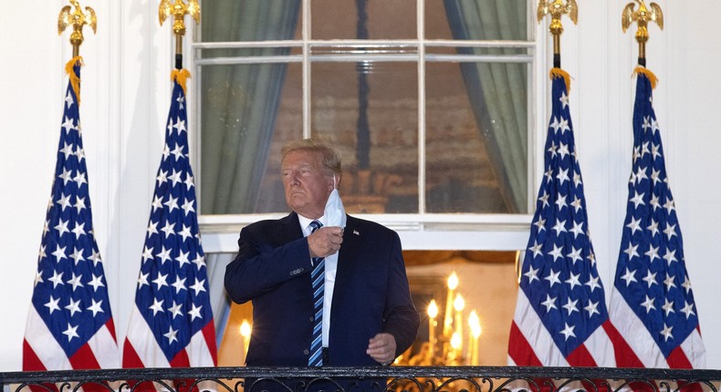 U.S. President Donald Trump removes his mask upon return to the White House