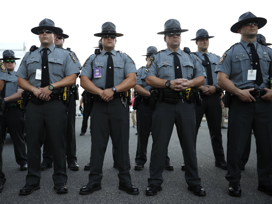 Pennsylvania State Troopers face off with Bernie Sanders supporters and delegates outside of the convention arena after they stormed off the convention floor in protest when Hillary Clinton won the Democratic presidential nomination during the second day at the Democratic National Convention in Philadelphia, Pennsylvania, U.S. July 26, 2016.