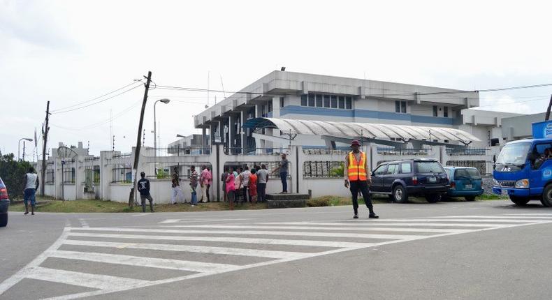 A road safety officer stands in front of a Central Bank of Nigeria building, following an explosion that killed some workers and injured many, in Calabar, Nigeria March 11, 2016. 