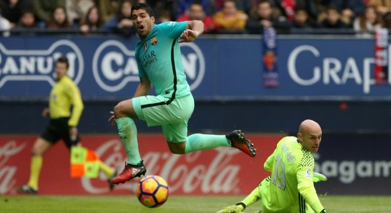 Barcelona forward Luis Suarez (L) has signed on to stay with the club until 2021