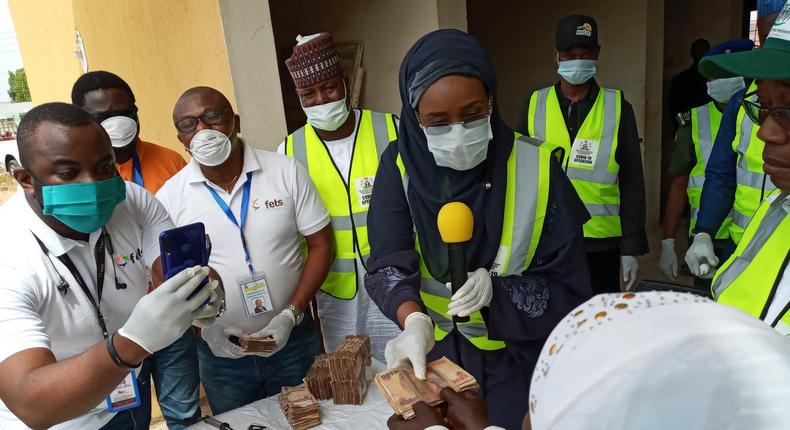 Hajiya Sadiya Umar Farouq, the Minister of Humanitarian Affairs, Disaster Management and Social Development sharing the Federal Government's Conditional Cash Transfer to beneficiaries. [Twitter/@BashirAhmaad]