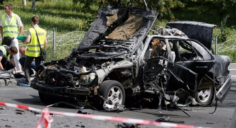 Investigators work at the scene of a car bomb explosion which killed Maxim Shapoval, a high-ranking official involved in military intelligence, in Kiev, Ukraine, June 27, 2017.