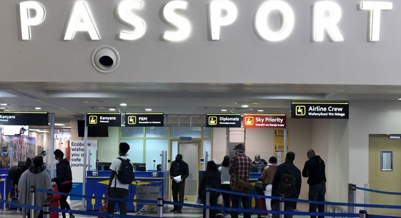 Passengers queue at passport control desks at the Jomo Kenyatta international airport in Nairobi, Kenya, on August 1, 2020. (Photo by SIMON MAINA/AFP via Getty Images)