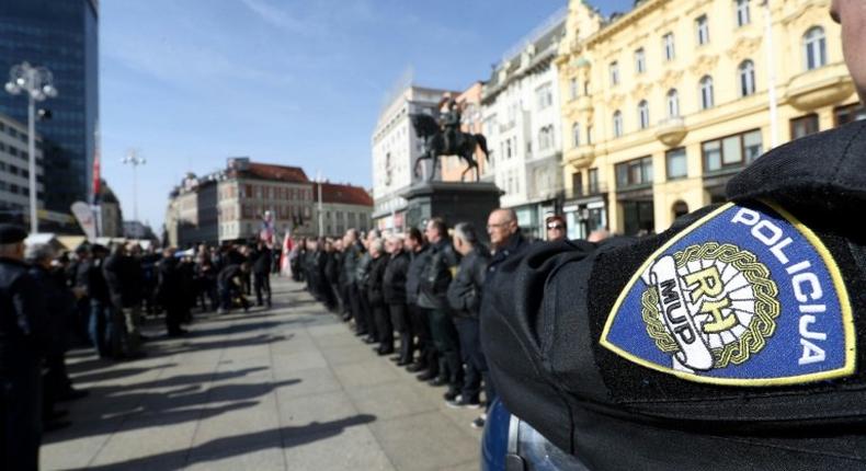 A police officer stands by as supporters of a Croatian far-right party gather in Ban Jelacic Square in downtown Zagreb on February 26, 2017