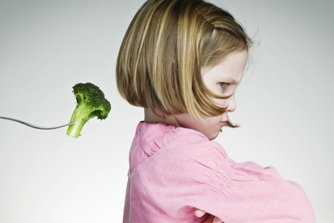 Young Girl Refusing To Eat Her Greens