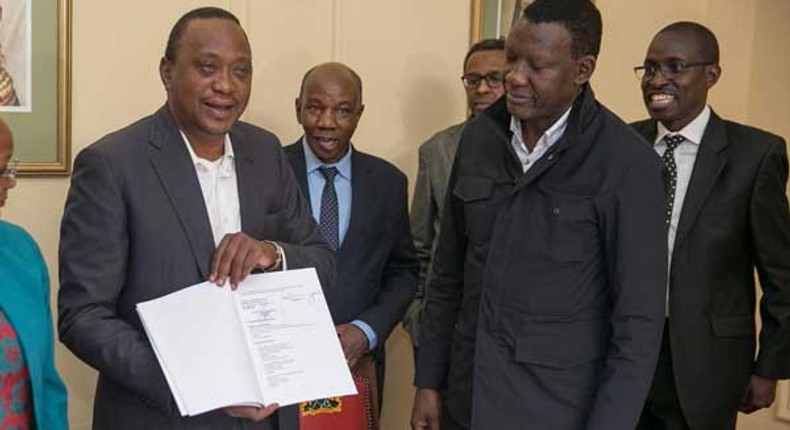 President Uhuru Kenyatta with his legal team including Evans Monari (back right)