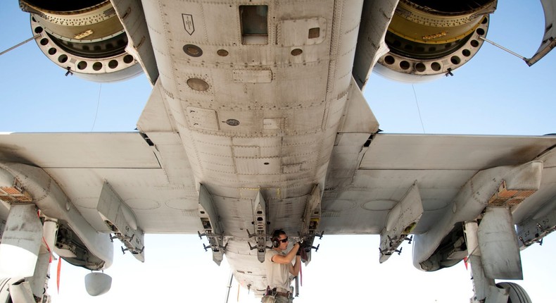 An airman inspects and cleans a rack on an A-10 Thunderbolt at Kandahar Airfield in Afghanistan on December 2, 2011.US Air Force/Senior Airman Corey Hook