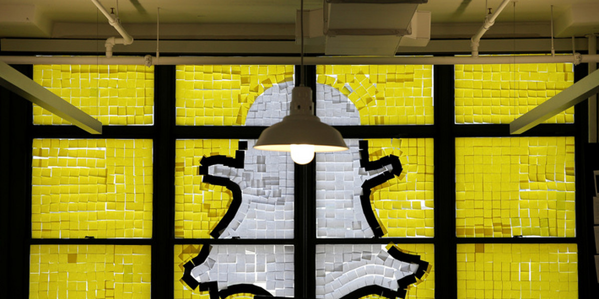 Snapchat logo image created with Post-it notes is seen in the windows of Havas Worldwide offices at 200 Hudson street in lower Manhattan, New York during "Post-it note war"